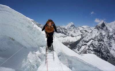Climber crossing the crevasse at Island peak
